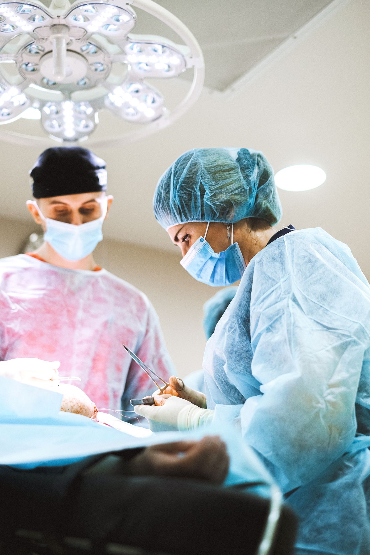 Two anesthesia clinicians focused at the operating table